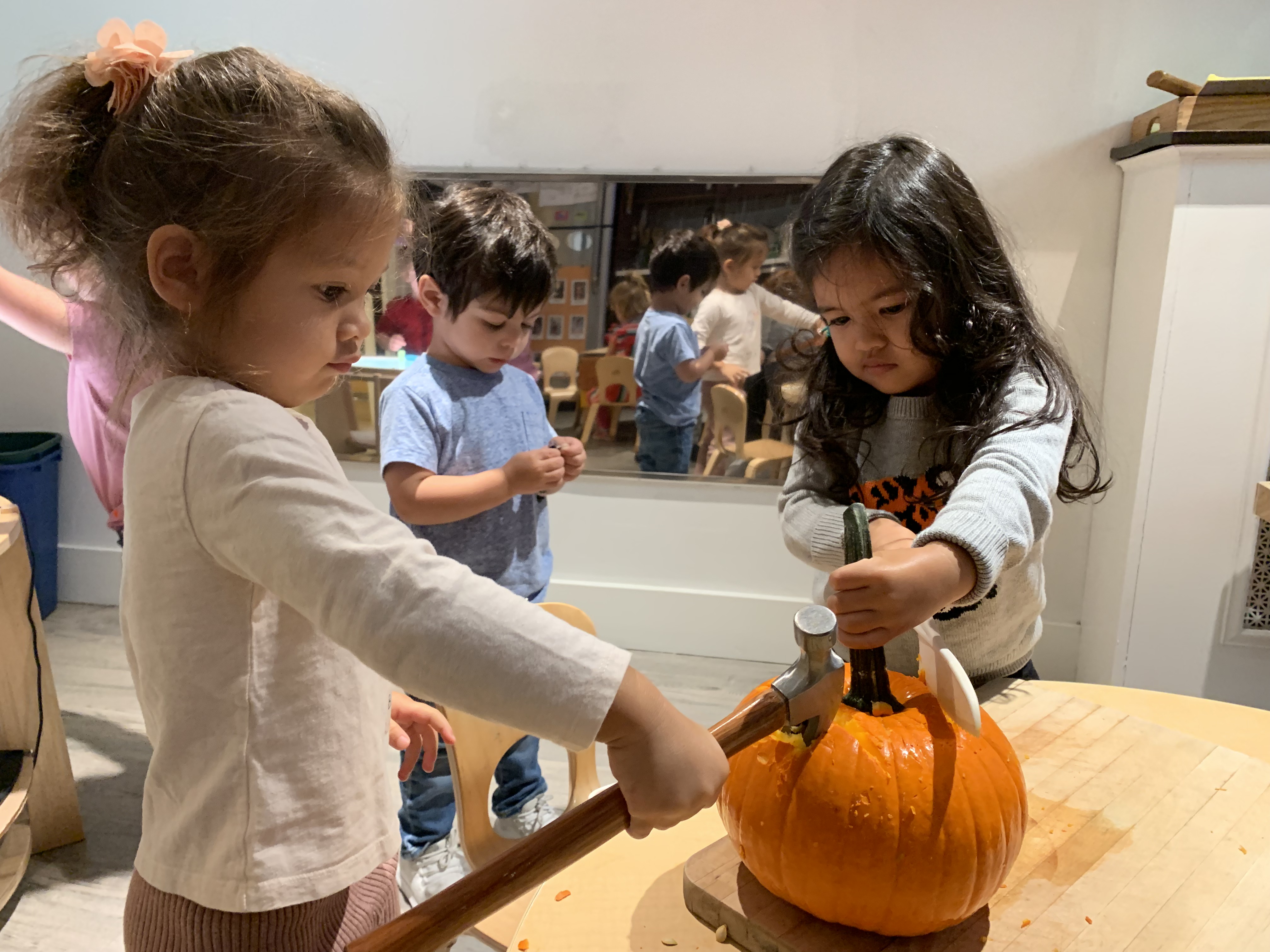 children smashing pumpkins