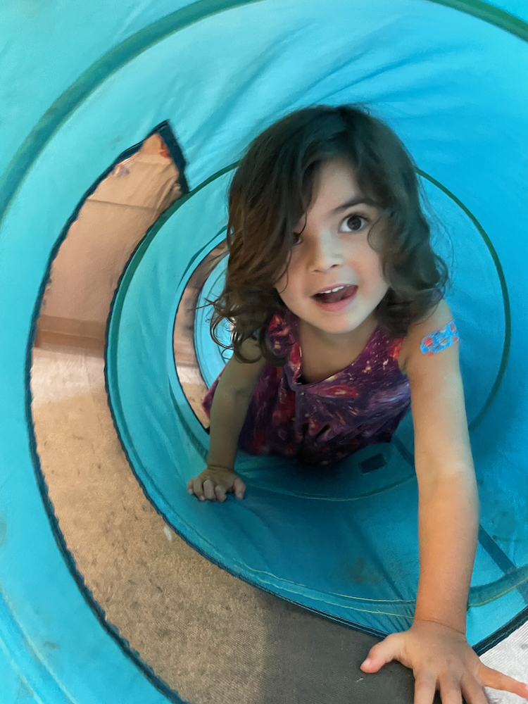 Child crawling through a tunnel