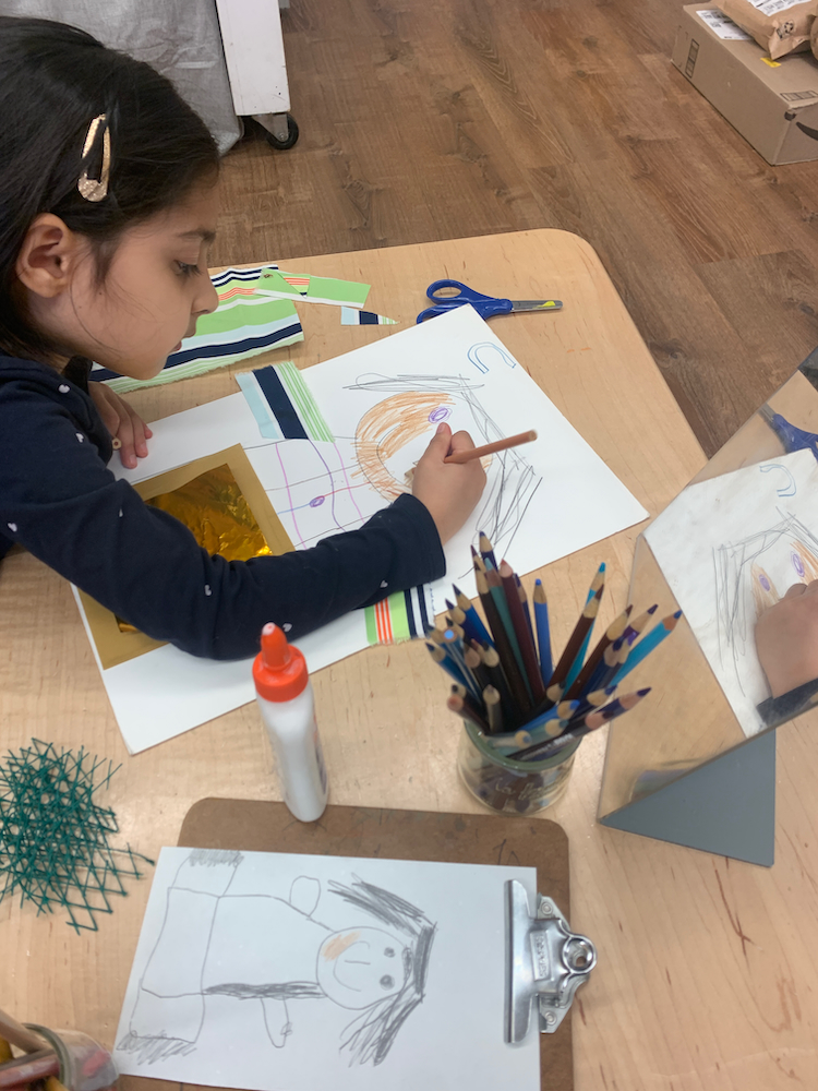 a child drawing a self portrait