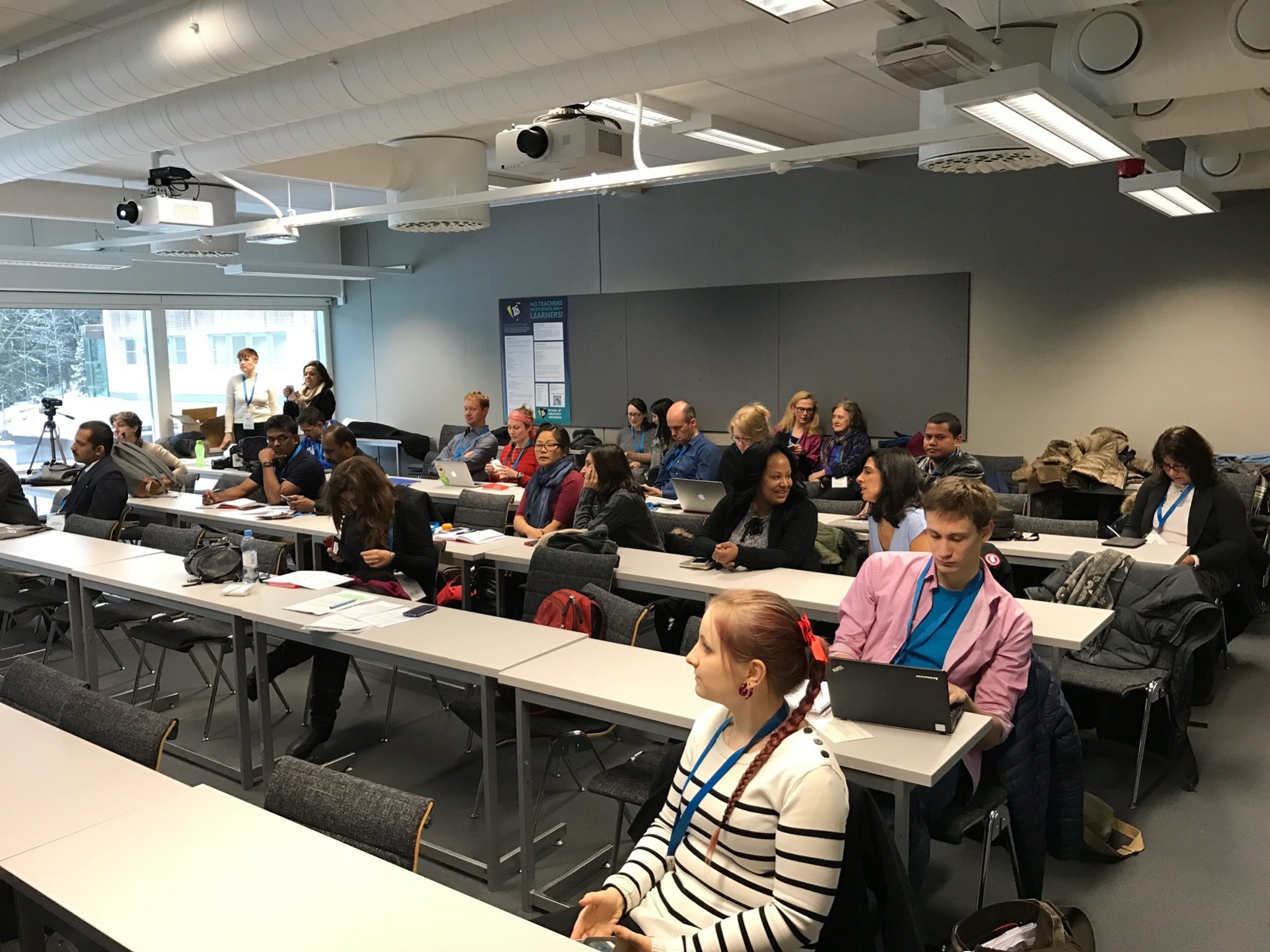 a crowd at a symposium