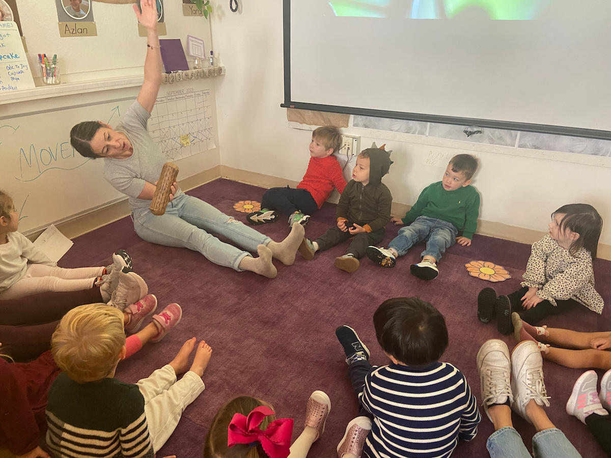 a circle of children leaning over