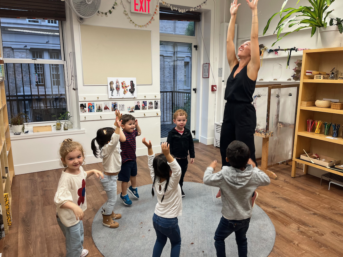 children reaching up to the sky