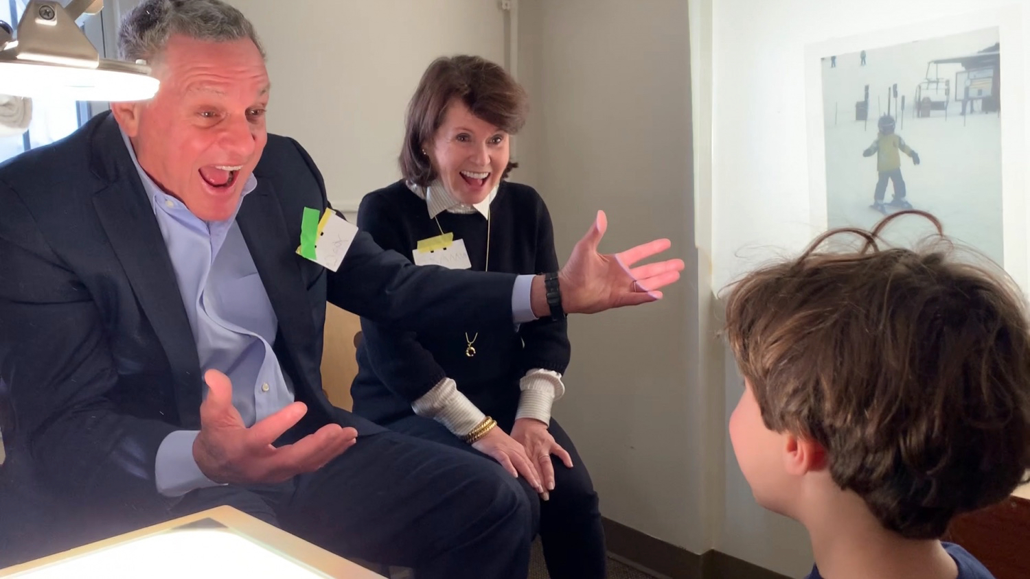 a grandparents telling a story with a light projector