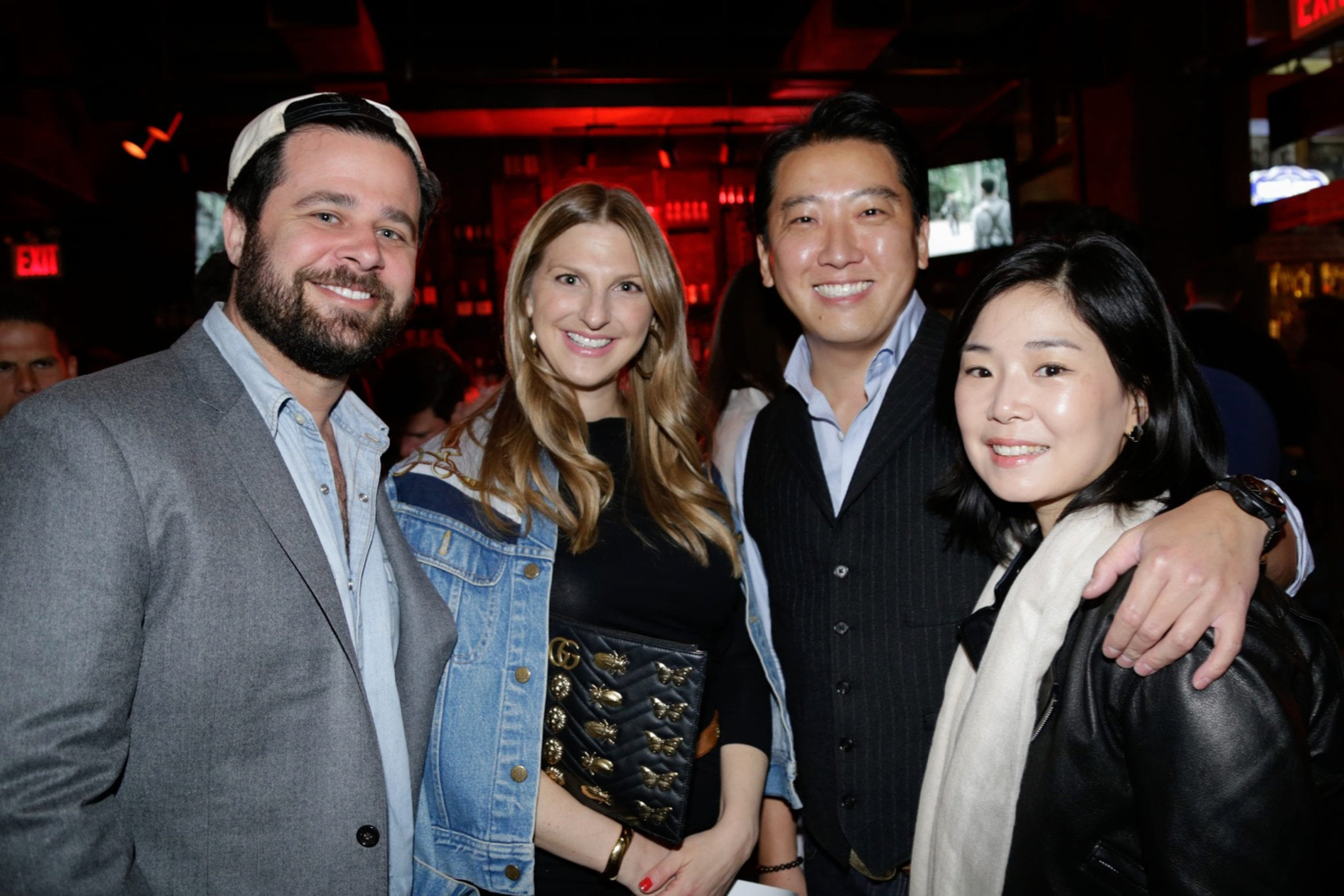 two couples posing at an auction event