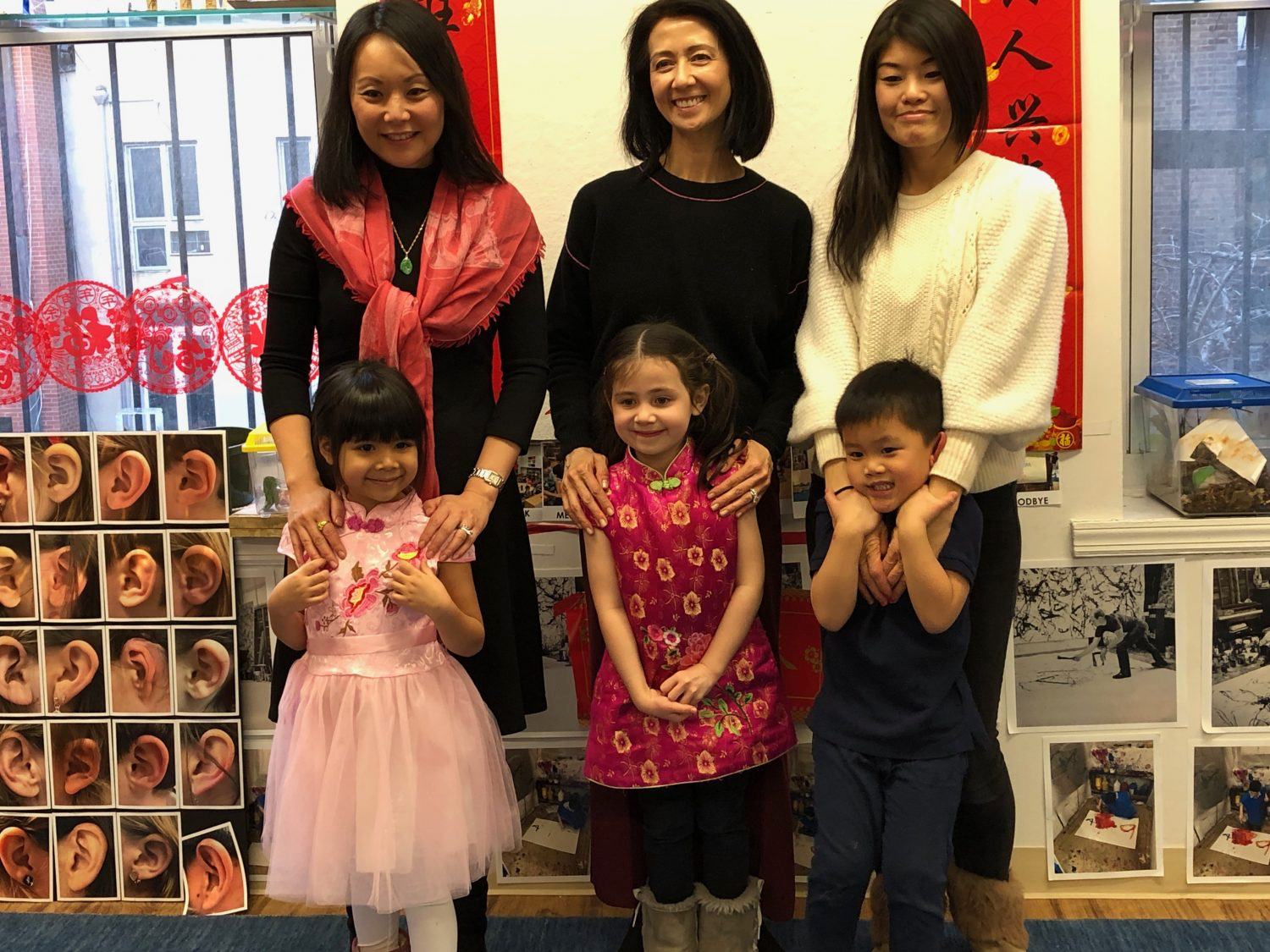 three children celebrating a cultural holiday together with their mothers