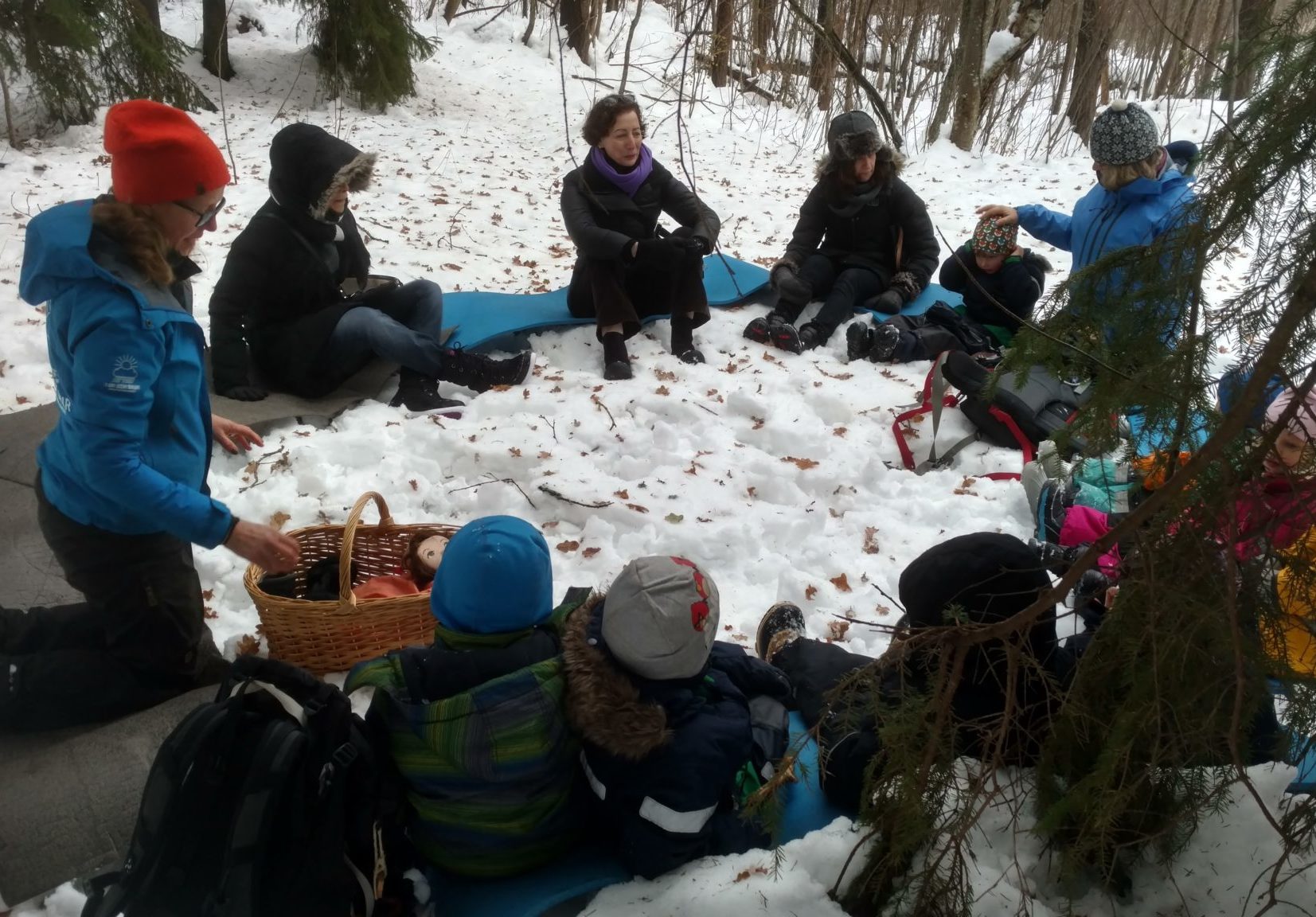a group of teachers sitting in a circle in the snow