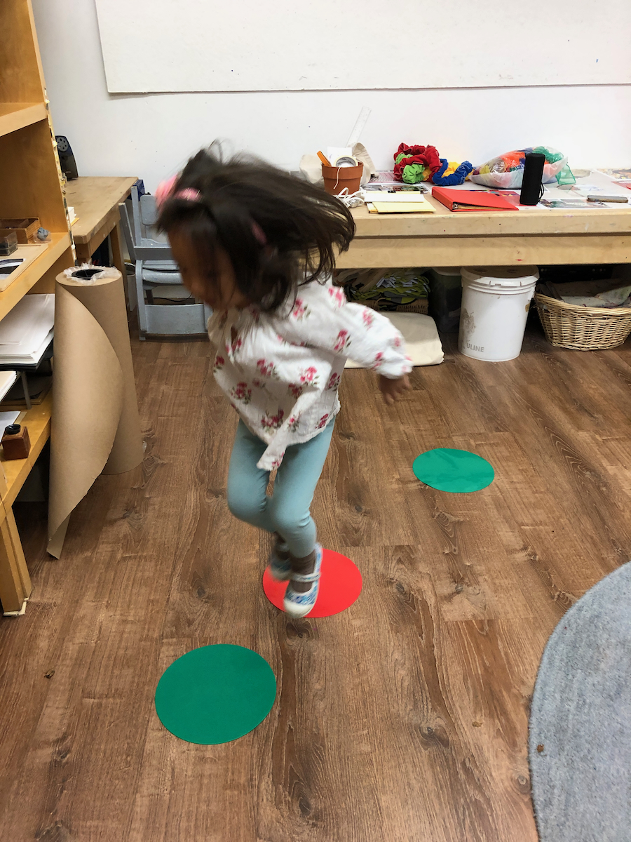 a child jumping on spots