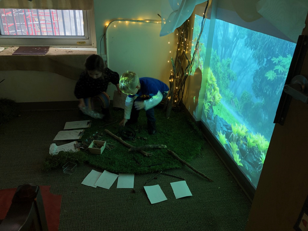 children arranging sticks inside