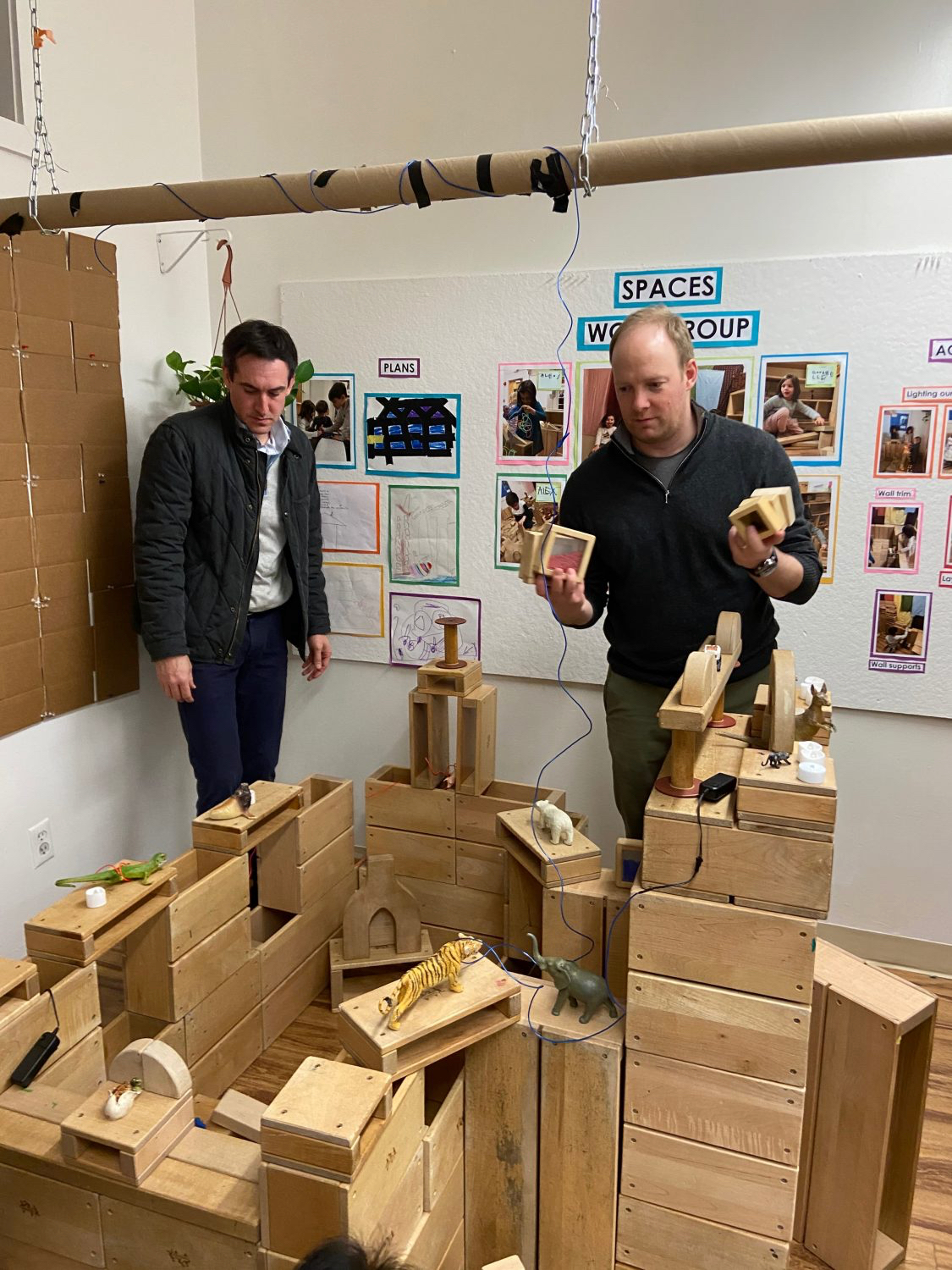 two dads building a block structure together