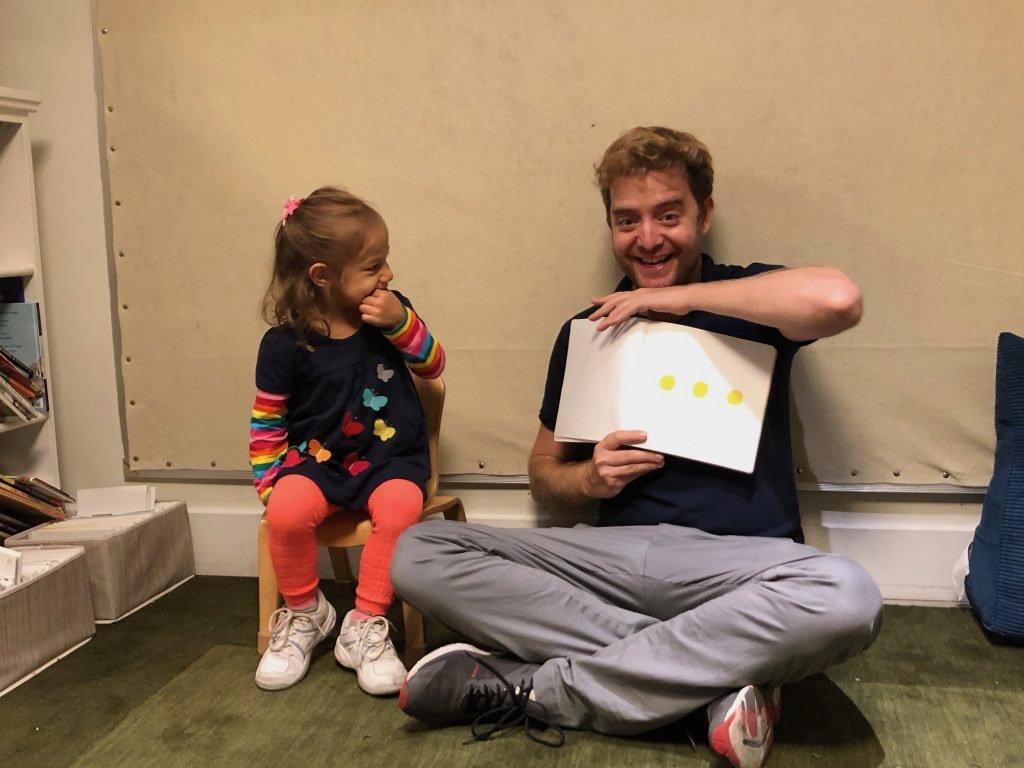 a father reading with his daughter